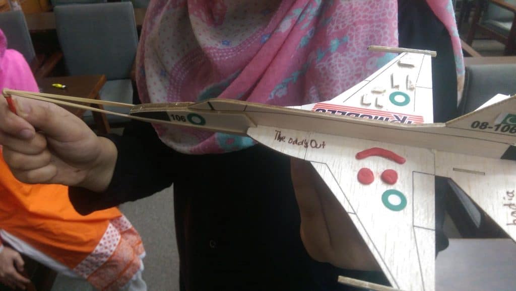 Kids presenting aircraft models