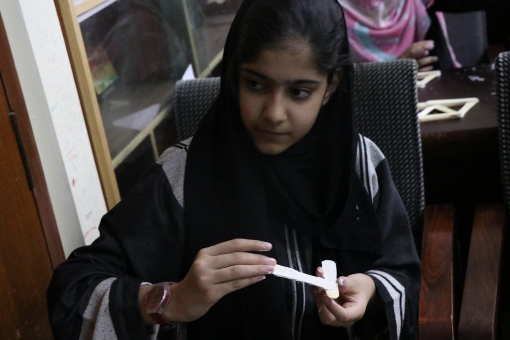 Focused girl building model