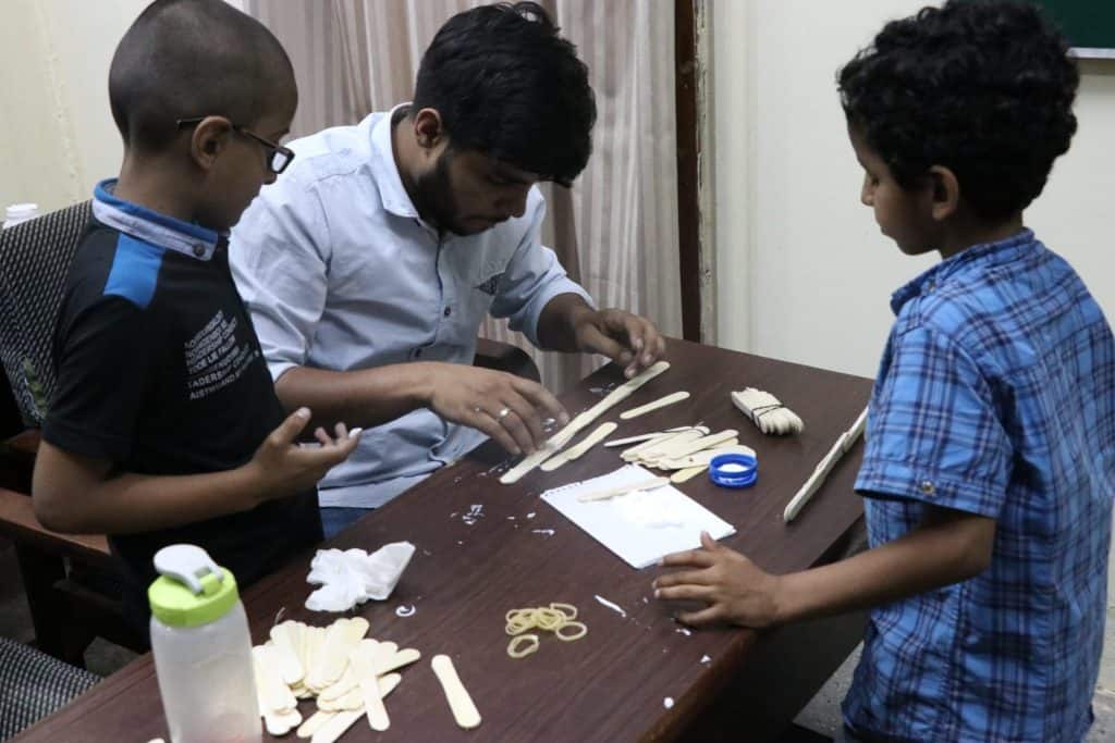 Kids with instructor at table