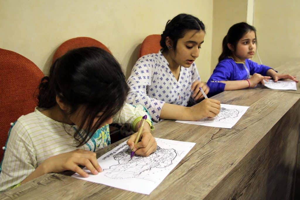 Girls drawing travel maps
